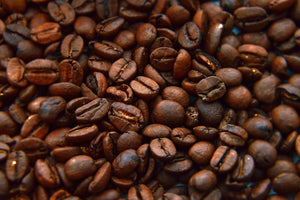 Close-up of roasted coffee beans with rich textures and deep brown color.