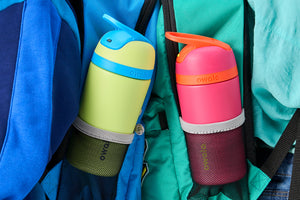 Two mini Owala flip water bottles in kids backpack pockets