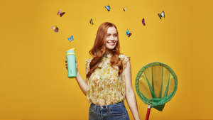A girl with butterflies behind her and she is holding an Owala bottle