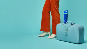 Person with a suitcase for a road trip and an Owala water bottle